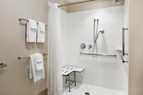 a white bathroom with a shower and a toilet at Holiday Inn Express & Suites - Prosser - Yakima Valley Wine by IHG in Prosser