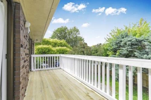 a balcony with a white railing and trees at Central Location Spacious Comfortable House in Auckland