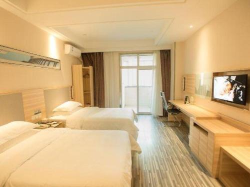 a hotel room with two beds and a flat screen tv at City Comfort Inn Hotel Wuhan Optics Valley Square Metro Station Zhongnan Minzu University in Wuhan