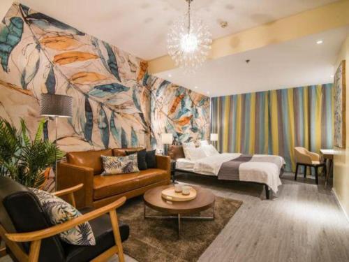 a living room with a couch and a bed at Jinzhou International Business Hotel in Guangzhou