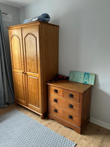 a wooden cabinet and a dresser in a room at Kilmagner in Letterkenny