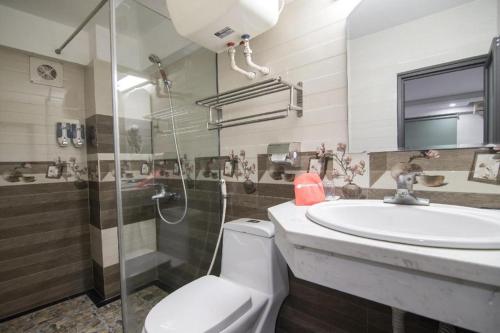 a bathroom with a toilet and a sink and a shower at Ha Noi Vang Hotel Hoang Ngan in Hanoi