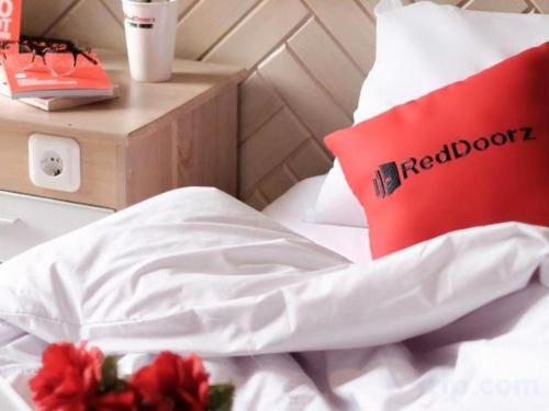 a bed with a red book on top of it at Ha Noi Vang Hotel Hoang Ngan in Hanoi