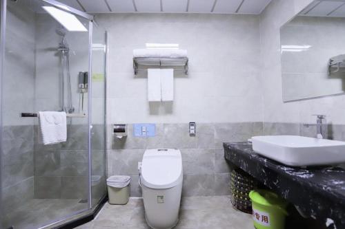 a bathroom with a toilet and a sink and a shower at Yanji Yanbian International Hotel in Yanji