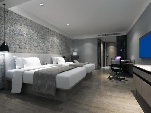 Cama o camas de una habitación en Shenzhen Hanyong Hotel Fuyong Branch