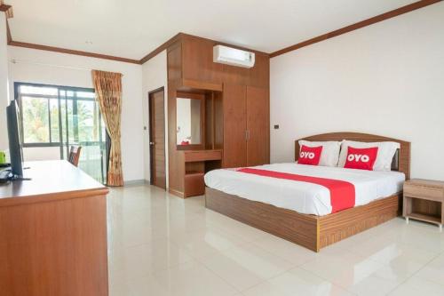 a bedroom with a bed and a television in it at OYO 732 Juthamas Hotel in Patong Beach
