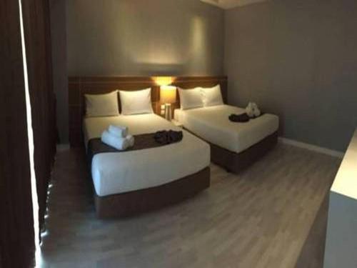 a hotel room with two beds in a room at Tanzeno Hotel in Nong Khai