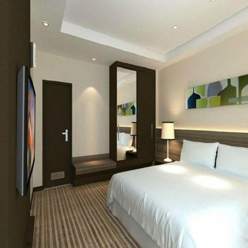 Кровать или кровати в номере Xiamenair Maple Hotel (Xiamen SM City Plaza)