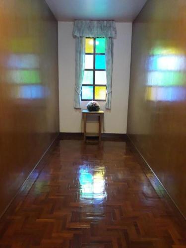 an empty room with a table and a window at OYO 769 Ban Thassanee in Chiang Mai