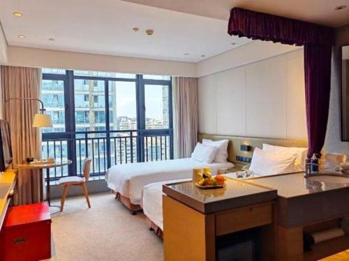 a hotel room with a bed and a balcony at New Century Kylie Hotel Ningbo in Ningbo