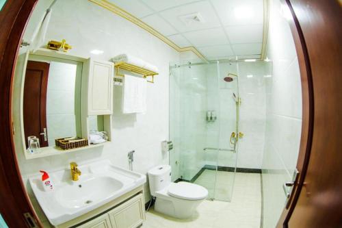 a bathroom with a shower and a toilet and a sink at BACNINH HARMONY HOTEL in Bắc Ninh