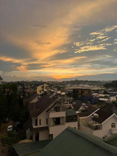 a view of a city with the sunset in the background at Amelia House - Boutique Hotel in Khu Chi Lăng