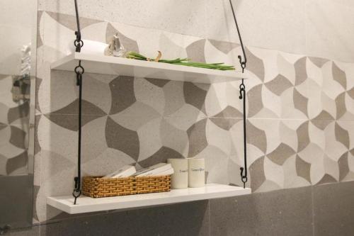 a shelf in a bathroom with a patterned wall at Green Oasis Hotel in Phường Sáu