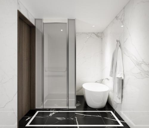 a bathroom with a glass shower and a sink at The Siena PRIMO in Seogwipo