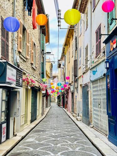 an empty street with balloons and balloons hanging from buildings at Artistic Antibes Apartment in Antibes