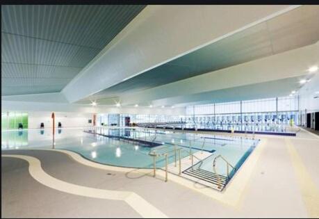a large swimming pool in a large building at Lakeside Executive Retreat near Westfield Shops in Perth