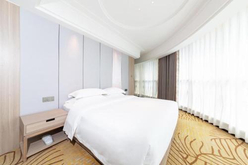 Ένα ή περισσότερα κρεβάτια σε δωμάτιο στο Forstar Hotel Renbei subbranch