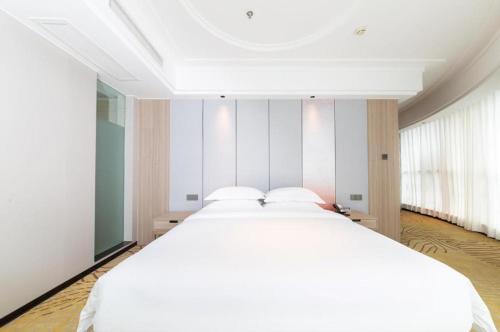Ένα ή περισσότερα κρεβάτια σε δωμάτιο στο Forstar Hotel Renbei subbranch