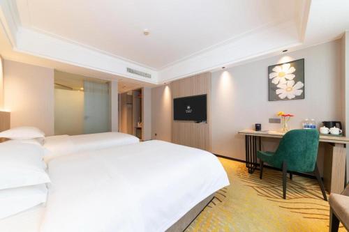 Ένα ή περισσότερα κρεβάτια σε δωμάτιο στο Forstar Hotel Renbei subbranch