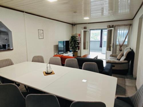 a meeting room with a white table and chairs at L'Etape du Bonheur in Cilaos