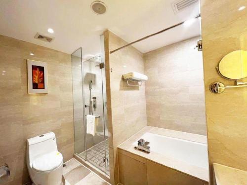 a bathroom with a shower and a toilet and a sink at Hohhot Hai Liang Plaza Hotel in Hohhot