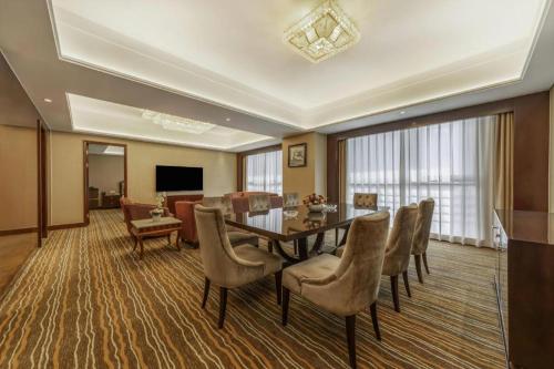 a dining room with a table and chairs at Hohhot Hai Liang Plaza Hotel in Hohhot