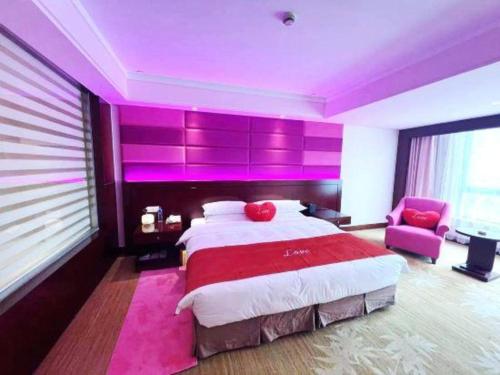 a bedroom with a large bed with purple lighting at Hohhot Hai Liang Plaza Hotel in Hohhot