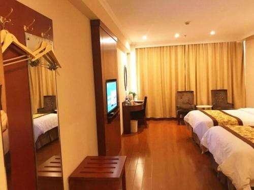 a hotel room with two beds and a television at GreenTree Inn AnHui Maanshan Dangtu High Speed Railway East Station RT-Market Business Hotel in Ma'anshan