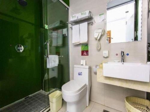 a bathroom with a toilet and a sink and a shower at Vatica Hengshui Halixun Peace Hospital Hotel in Hengshui
