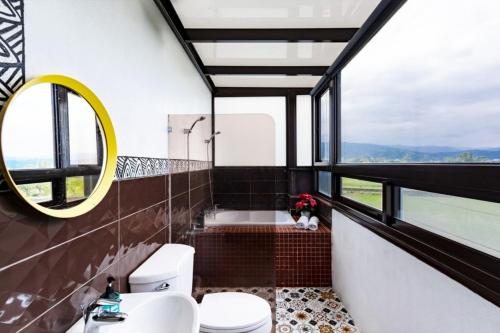 a bathroom with a toilet and a sink and a mirror at Hi Zebra Travel B&B in Dongshan