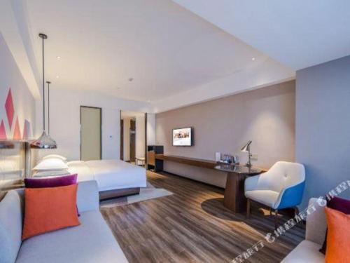 Ένα ή περισσότερα κρεβάτια σε δωμάτιο στο Borrman Hotel Nanning Railway Station