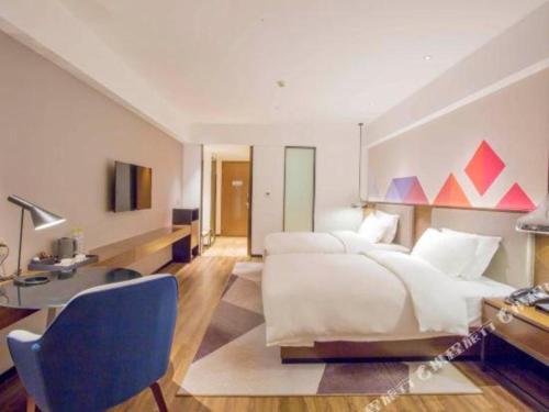 Ένα ή περισσότερα κρεβάτια σε δωμάτιο στο Borrman Hotel Nanning Railway Station