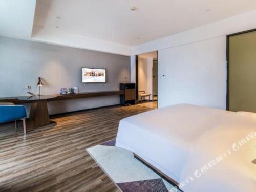 Ένα ή περισσότερα κρεβάτια σε δωμάτιο στο Borrman Hotel Nanning Railway Station