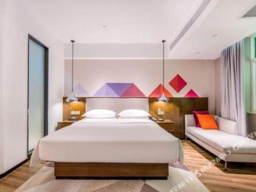 Ένα ή περισσότερα κρεβάτια σε δωμάτιο στο Borrman Hotel Nanning Railway Station