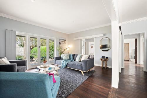 a living room with a couch and a table at Elva Garden Cottage in Margaret River Town