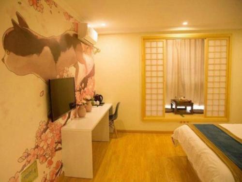 a bedroom with a cow painting on the wall at Shell Shanghai Songjiang District Xinqiao Town Xinqiao Hotel in Chunshen