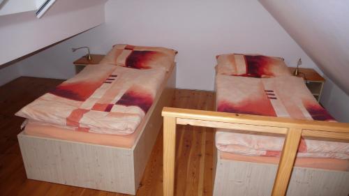 a room with two bunk beds in a attic at Penzion Padrtův mlýn in Třebíč