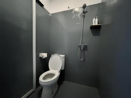 a bathroom with a toilet and a shower at Casa Due in Canggu