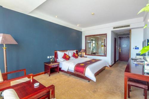 a bedroom with a bed and a blue wall at Datong Tiangui International Hotel in Datong