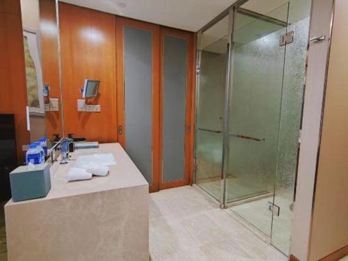 a bathroom with a sink and a shower at Dusit D2 Binhu Changzhou Hotel in Changzhou