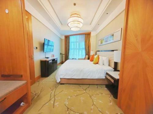 a large bedroom with a bed and a television at Dusit D2 Binhu Changzhou Hotel in Changzhou