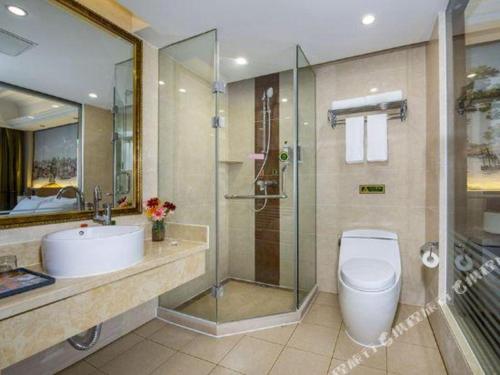 a bathroom with a toilet and a sink and a shower at Vienna Hotel Tianjin Huaming in Tianjin
