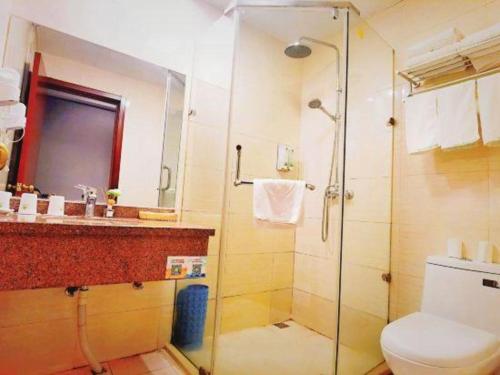 a bathroom with a shower and a toilet and a sink at GreenTree Inn Suzhou Shihu Suli Road Express Hotel in Suzhou