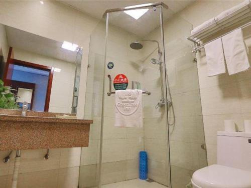 a bathroom with a shower and a toilet and a sink at GreenTree Inn Suzhou Shihu Suli Road Express Hotel in Suzhou