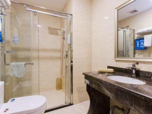 a bathroom with a shower and a sink and a toilet at GreenTree Inn Hefei Huangshan Road Daxidi 1912 Express Hotel in Hefei