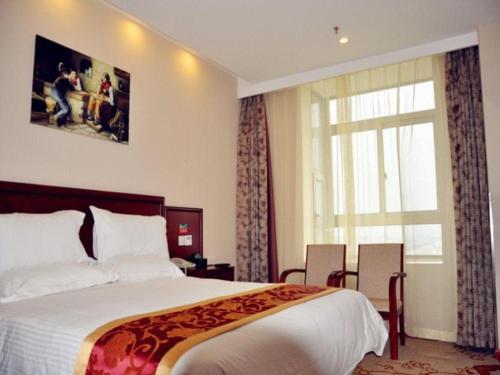 a hotel room with a large bed and a window at GreenTree Inn Shanghai Jiading Newtown MaLu Subway Station Business Hotel in Jiading