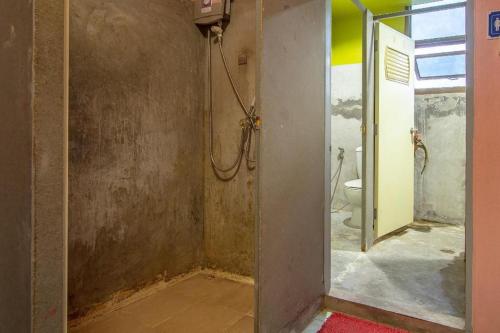 a bathroom with a shower and a toilet at OYO 586 I Hostel Phuket in Patong Beach
