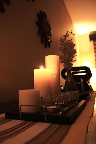 a tray with candles and glasses on a table at Thunderbird Resorts - Poro Point in San Fernando