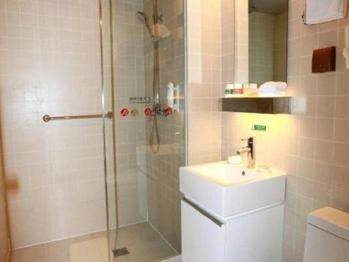 a bathroom with a shower and a sink at Jinjiang Inn Xi'an Zhonglou North Street Metro Station in Xi'an