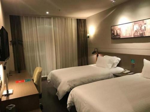 Ένα ή περισσότερα κρεβάτια σε δωμάτιο στο Jinjiang Inn Select Xuzhou Suining Middle Yuanfu Road